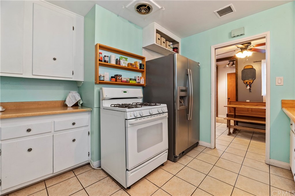 4140 St George Place Riverside, CA 92504 - Photo 28 of 29 a kitchen with stainless steel appliances a refrigerator sink and cabinets