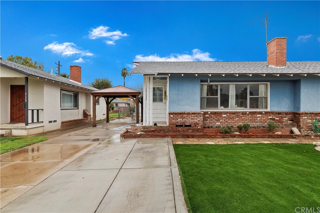 4140 St George Place Riverside, CA 92504 - Photo 5 of 29 a front view of a house with swimming pool and a yard