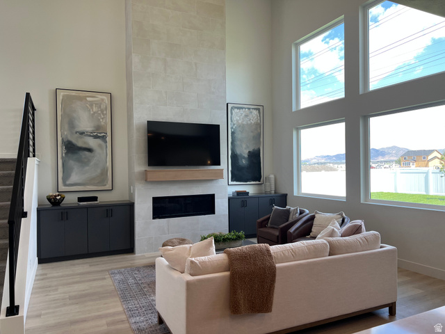 1951 2900 West Provo, UT 84601 - Photo 5 of 21 Two-story living area with a floor-to-ceiling tiled fireplace and an integrated linear electric fireplace