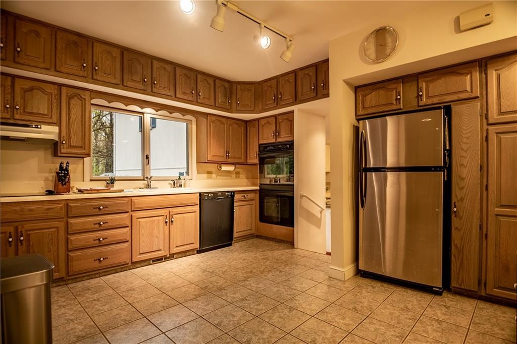 1355 Yahres Road Sharon, PA 16146 - Photo 26 of 33 a kitchen with granite countertop a refrigerator and cabinets