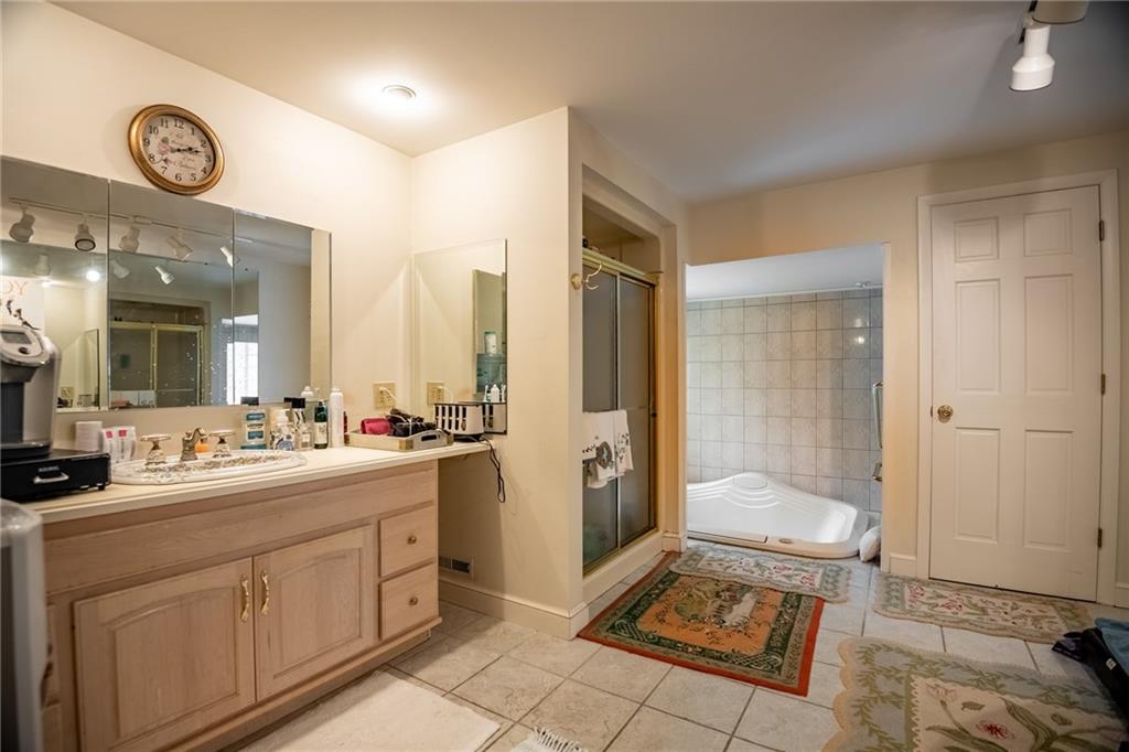 1355 Yahres Road Sharon, PA 16146 - Photo 31 of 33 a spacious bathroom with a double vanity sink a mirror and a shower