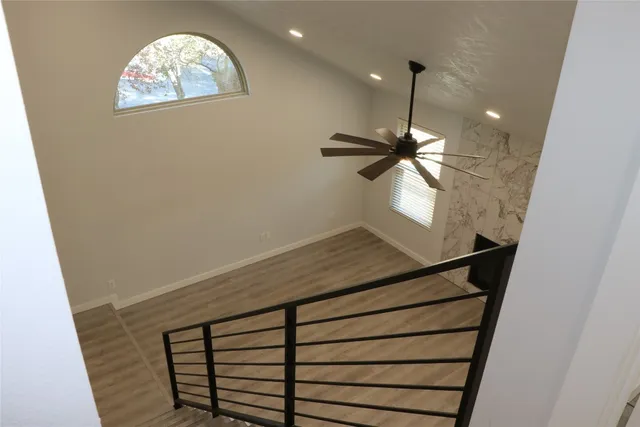 an empty room with wooden floor and cabinet