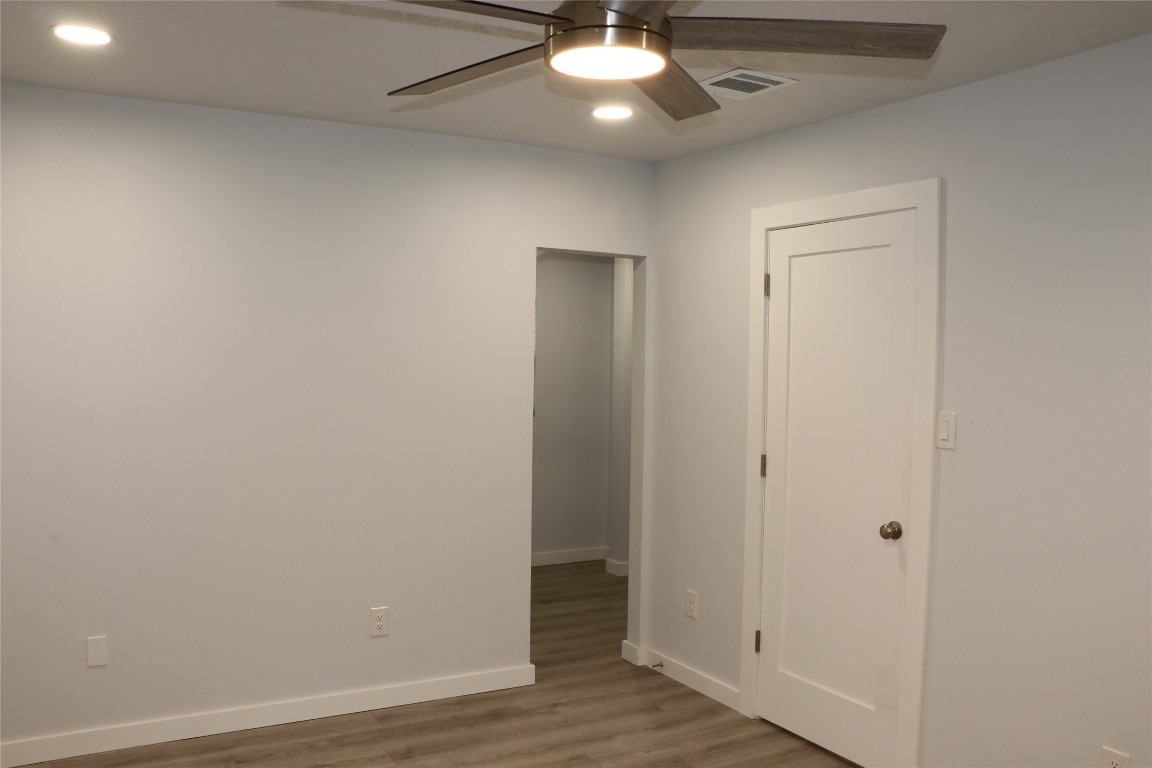 8903 Mesa Drive, Unit A Austin, TX 78759 - Photo 20 of 27 an empty room with wooden floor