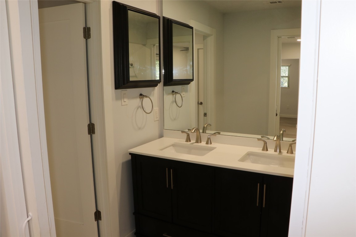 8903 Mesa Drive, Unit A Austin, TX 78759 - Photo 24 of 27 a bathroom with double sink and two mirror