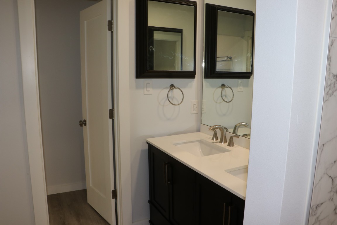 8903 Mesa Drive, Unit A Austin, TX 78759 - Photo 25 of 27 a bathroom with a sink vanity and mirror