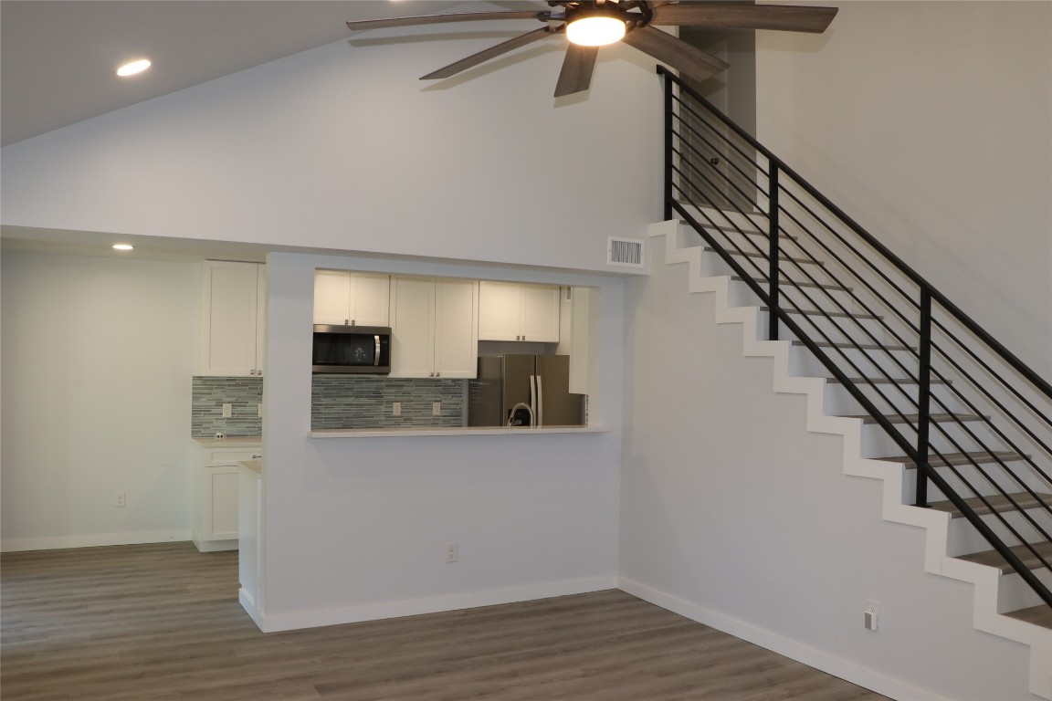 8903 Mesa Drive, Unit A Austin, TX 78759 - Photo 4 of 27 a view of a hallway with wooden floor and staircase