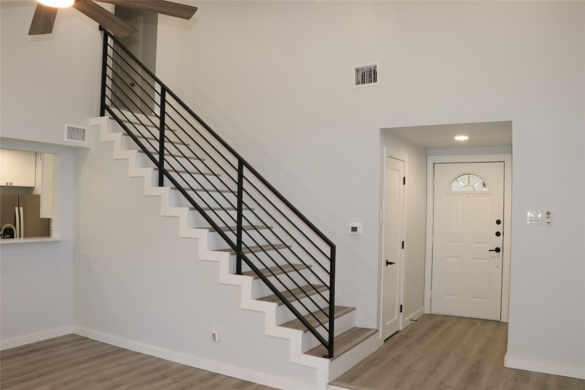 8903 Mesa Drive, Unit A Austin, TX 78759 - Photo 5 of 27 a view of staircase with wooden floor and white walls