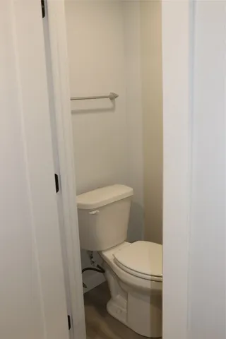 a white toilet sitting next to a shower