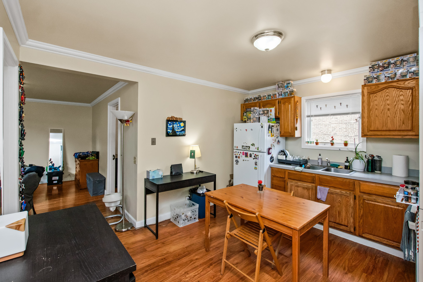 2238 West 21st Place Chicago, IL 60608 - Photo 20 of 37 a kitchen with a dining table chairs and a refrigerator