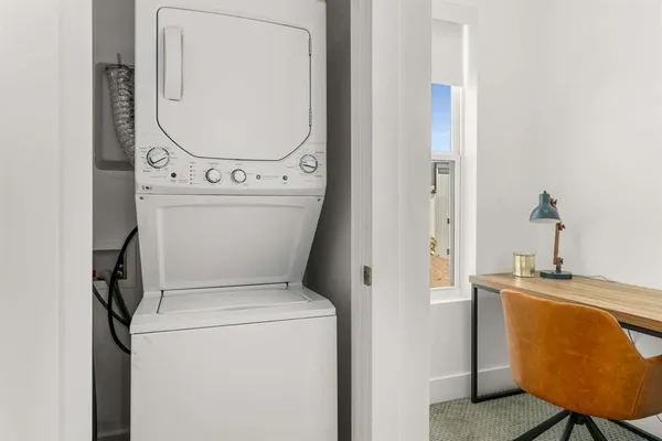 a large bed sitting in a bedroom next to a window