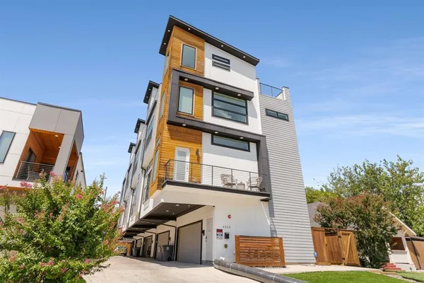 a living room with furniture kitchen view and a chandelier