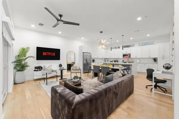 a living room with furniture kitchen view and a table