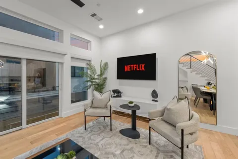 a kitchen with a dining table chairs sink and white cabinets