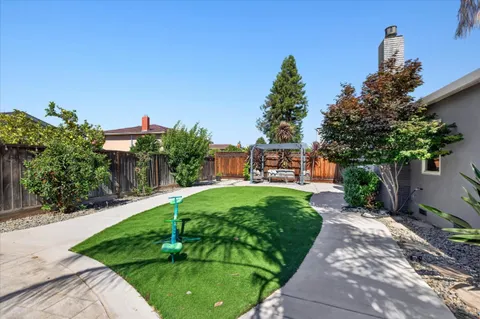a view of a garden with a bench in patio