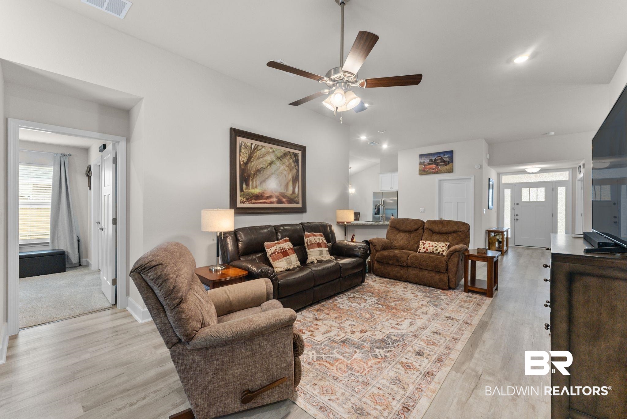 692 Mayflower Drive Foley, AL 36535 - Photo 11 of 40 Living room featuring healthy amount of natural light, a ceiling fan, light wood finished floors, and lofted ceiling