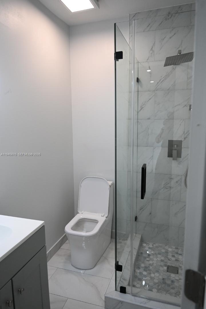 7545 Northwest 3rd Avenue, Unit 4 Miami, FL 33150 - Photo 3 of 6 a bathroom with a toilet and a shower