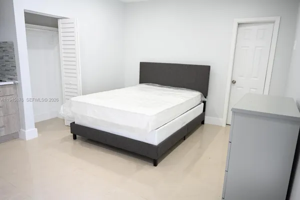 a bed sitting in a bedroom next to a window