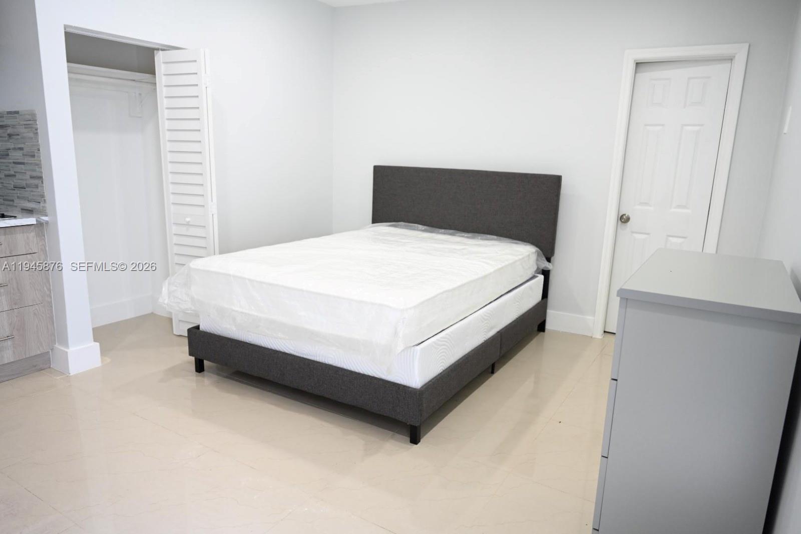 7545 Northwest 3rd Avenue, Unit 4 Miami, FL 33150 - Photo 5 of 6 a bed sitting in a bedroom next to a window