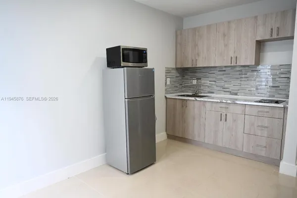 a kitchen with cabinets and stainless steel appliances