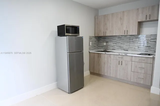 a kitchen with cabinets and stainless steel appliances