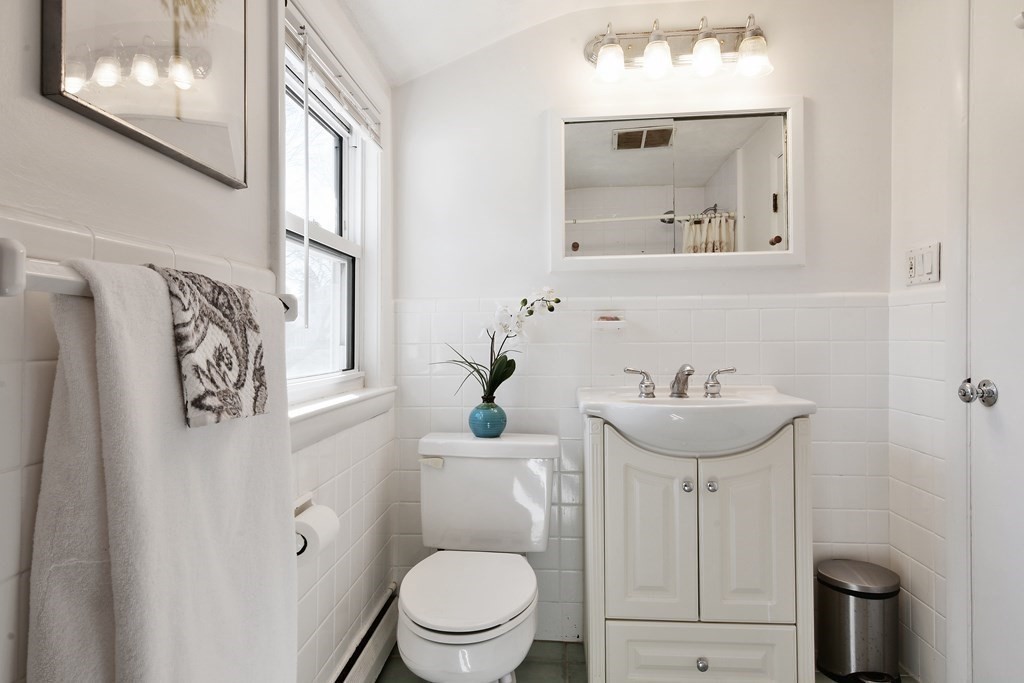 130 Florence Road Waltham, MA 02453 - Photo 17 of 26 a bathroom with a toilet sink and mirror
