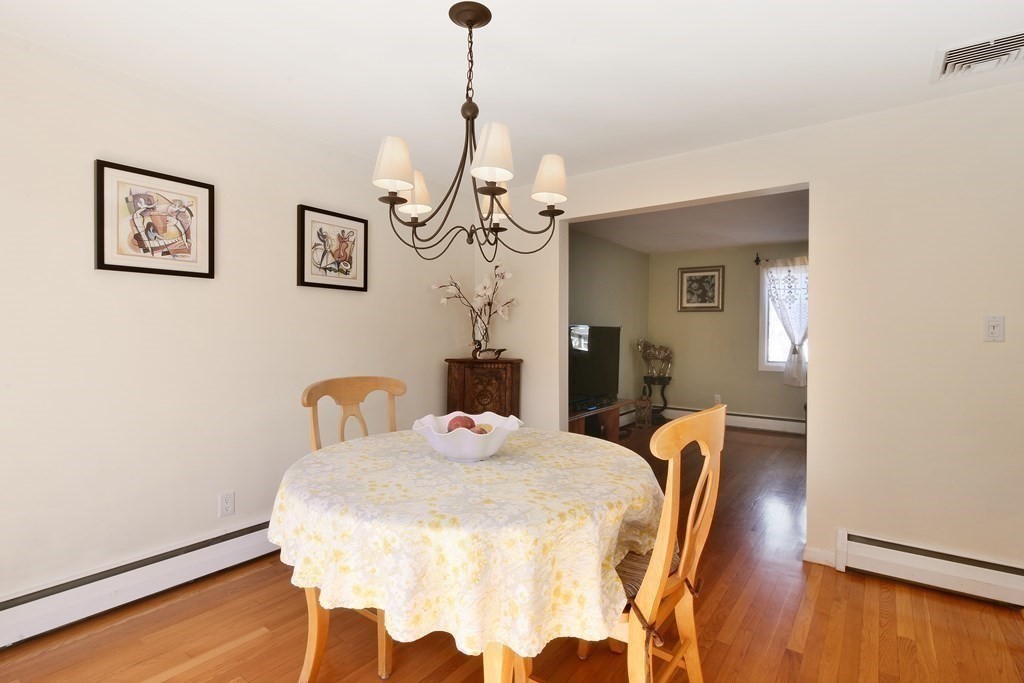 130 Florence Road Waltham, MA 02453 - Photo 8 of 26 a dining room with a wooden table and chairs