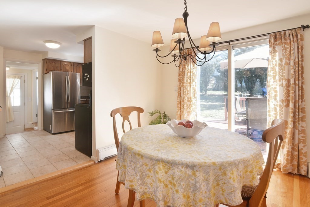 130 Florence Road Waltham, MA 02453 - Photo 9 of 26 a dining room with furniture a chandelier and wooden floor