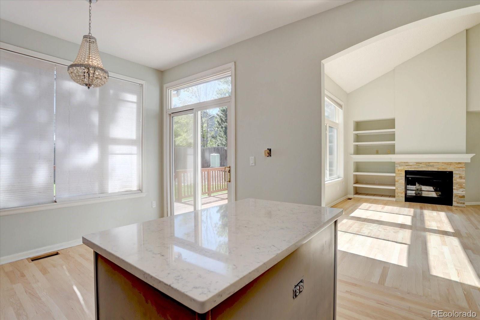 10312 Stoneflower Drive Parker, CO 80134 - Photo 11 of 43 a view of a kitchen counter top space and a fireplace