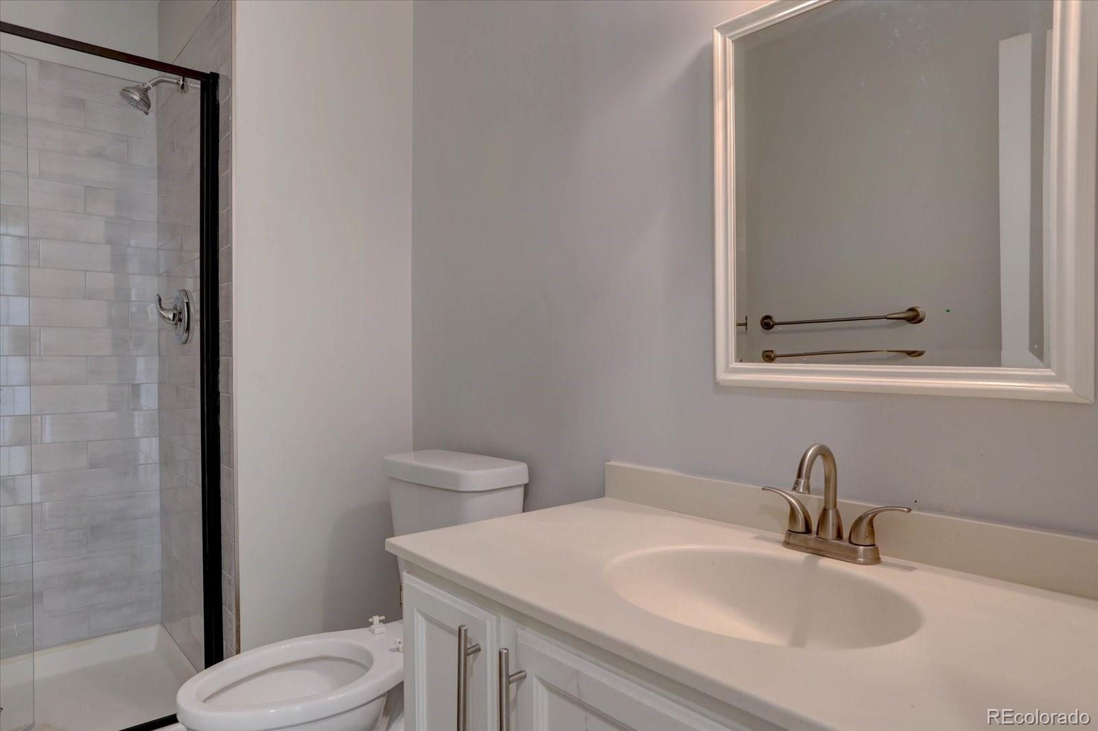 10312 Stoneflower Drive Parker, CO 80134 - Photo 17 of 43 a bathroom with a sink a toilet and shower