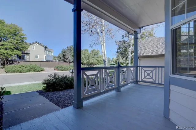 a view of a porch with wooden floor and fence