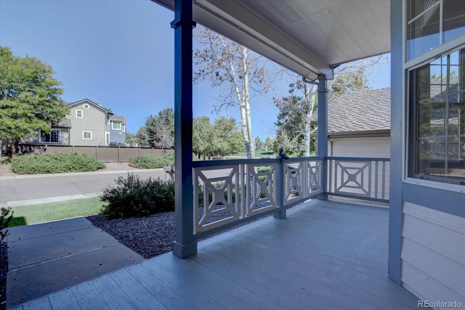 10312 Stoneflower Drive Parker, CO 80134 - Photo 2 of 43 a view of a porch with wooden floor and fence
