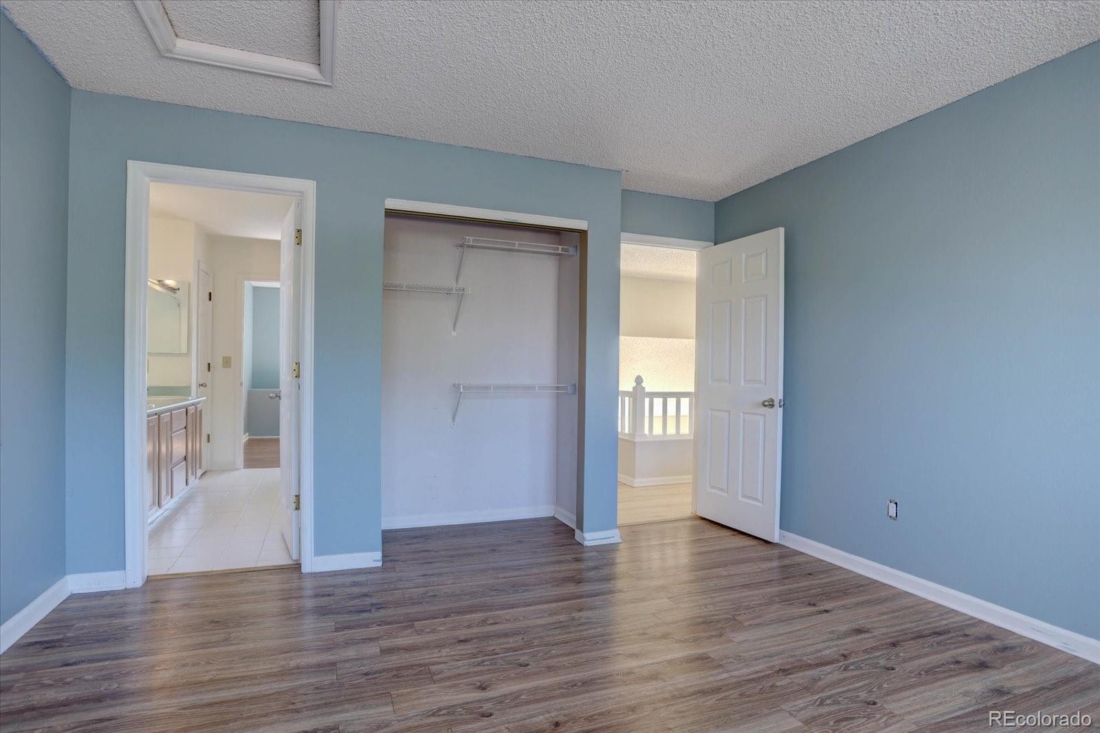 10312 Stoneflower Drive Parker, CO 80134 - Photo 24 of 43 a view of an empty room with wooden floor and a window