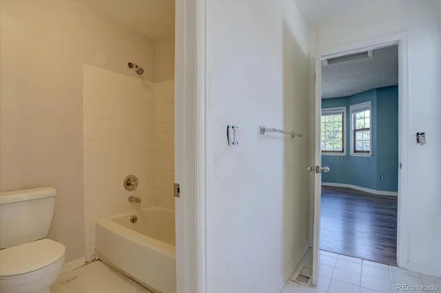 a bathroom with a toilet and a bathtub
