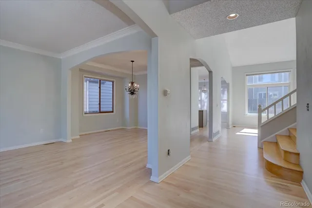 a view of an entryway with wooden floor and a livingroom