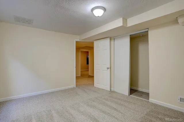 an empty room with closet area