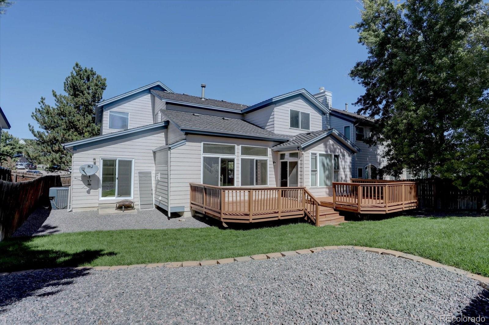 10312 Stoneflower Drive Parker, CO 80134 - Photo 37 of 43 a front view of a house with a garden and trees