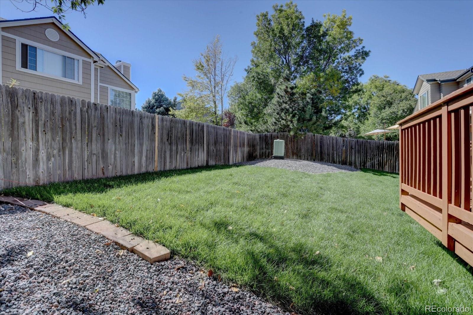 10312 Stoneflower Drive Parker, CO 80134 - Photo 39 of 43 a view of a backyard with a small cabin and wooden fence