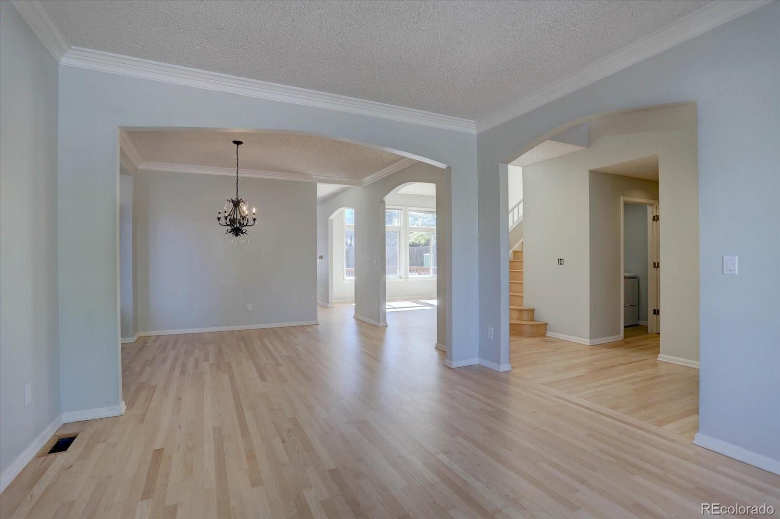 10312 Stoneflower Drive Parker, CO 80134 - Photo 5 of 43 a view of a livingroom with wooden floor