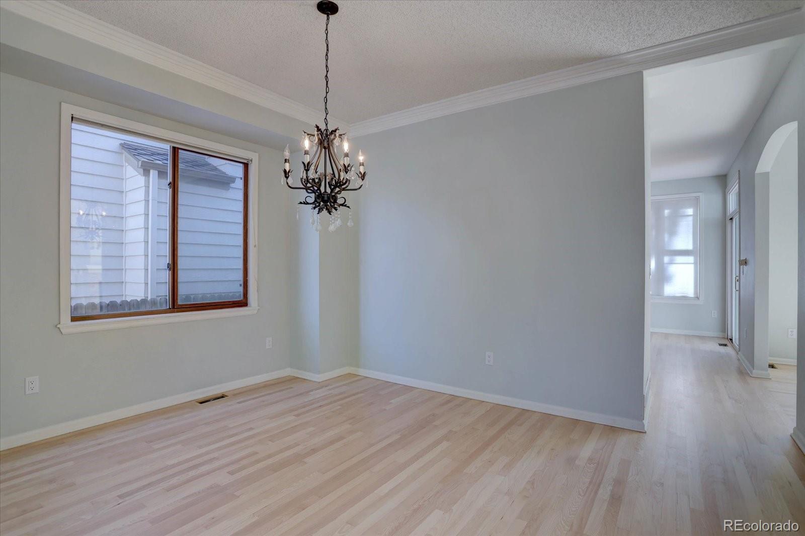 10312 Stoneflower Drive Parker, CO 80134 - Photo 6 of 43 a view of an empty room with wooden floor and a window