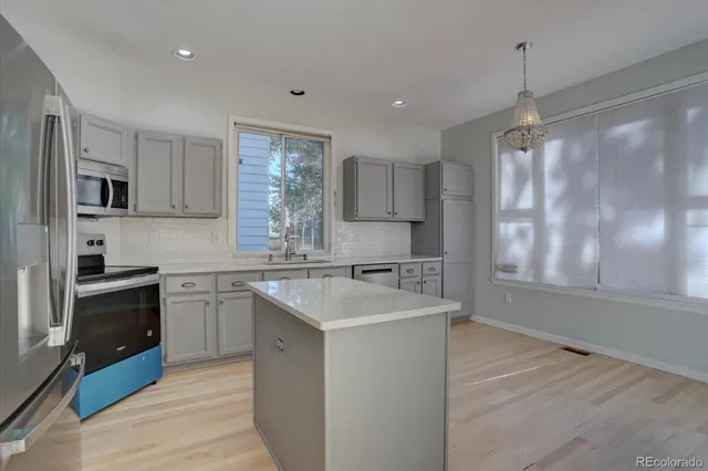 a kitchen with a sink stove and refrigerator