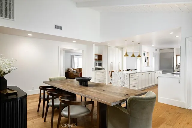 a dining room with furniture and wooden floor