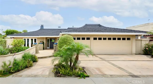 a front view of a house with a garden and pathway