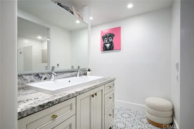 a bathroom with a granite countertop sink a toilet and a mirror