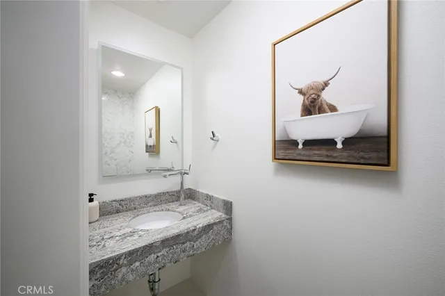 a bathroom with a granite countertop sink a mirror and a