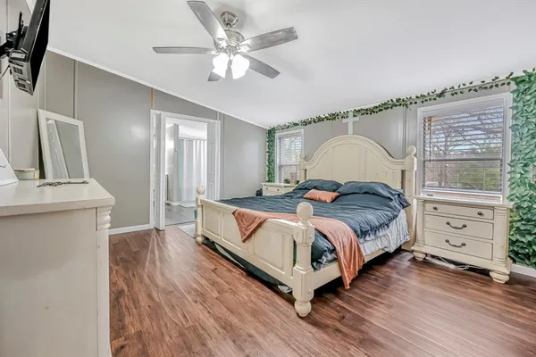 a spacious bedroom with a bed and a chandelier