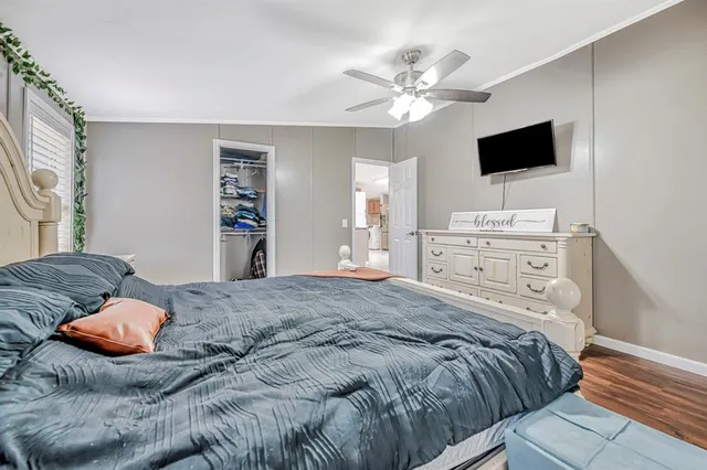 a bedroom with a bed and a flat screen tv