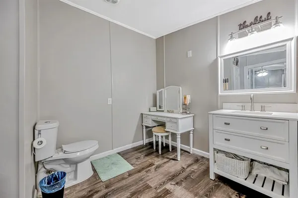 a bathroom with a toilet a sink and a mirror