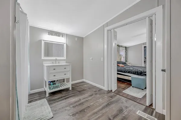 a view of a bedroom with baby crib and dresser