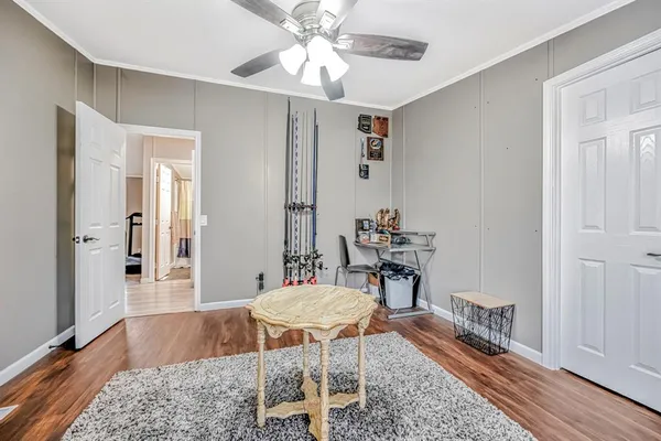 a work room with furniture and wooden floor