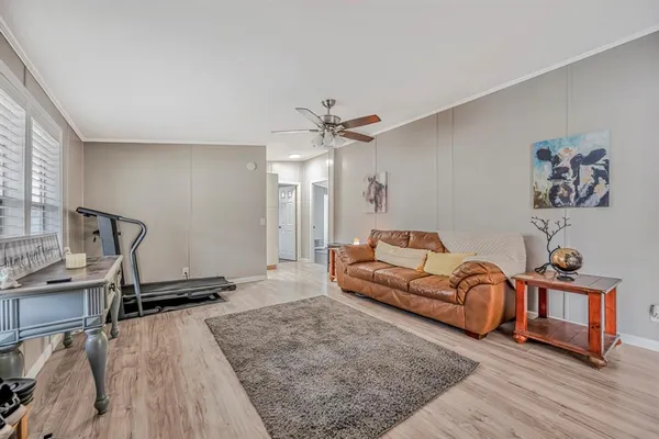 a living room with furniture and wooden floor
